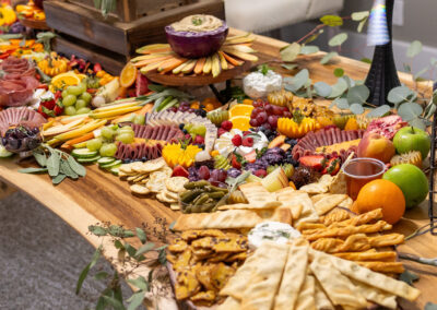 Elegant charcuterie grazing table with cheeses, meats, and fruits—perfect for weddings & upscale events.
