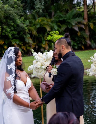 Romantic lakeside wedding vows with lush white florals at Saint Patrick Palace.
