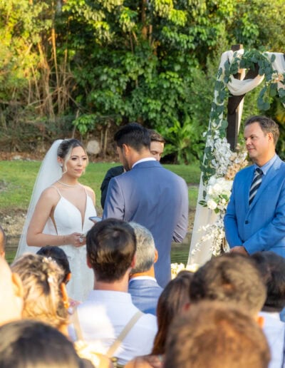 Romantic waterfront wedding with a floral arch at Saint Patrick Palace.
