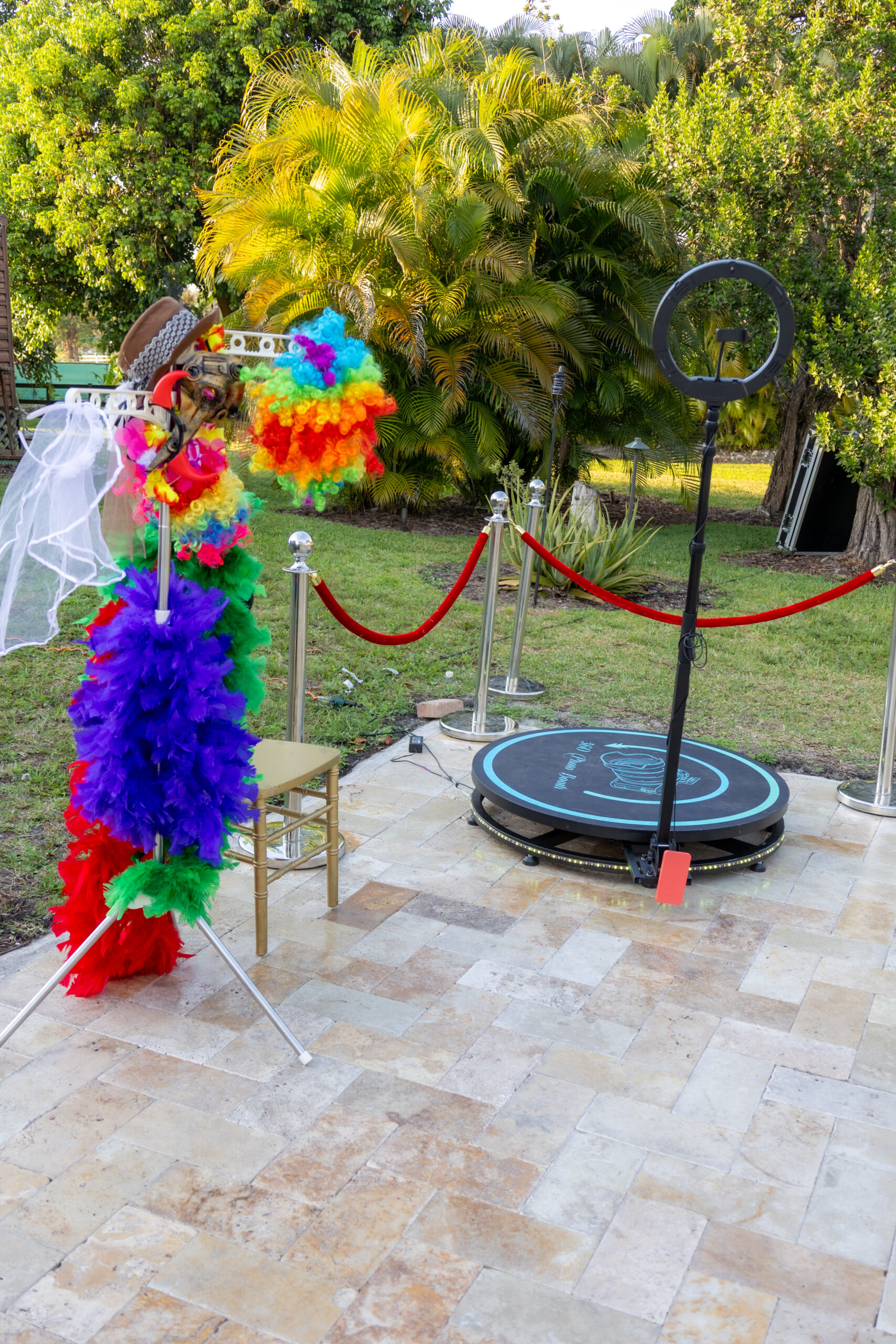 360 photo booth with props and red rope stanchions for parties and milestone celebrations.