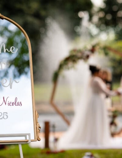 Elegant mirror welcome sign for Jessica & Nicolas’s outdoor wedding at Saint Patrick Palace.