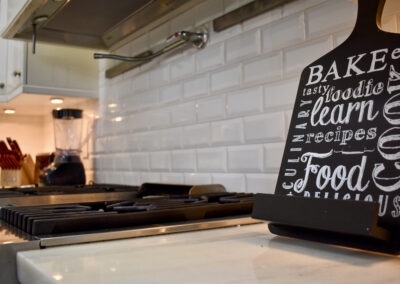 Gourmet kitchen with gas range, subway tile backsplash, and modern appliances at Saint Patrick Palace