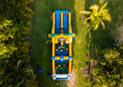 Vibrant inflatable sports obstacle course for parties, with slides and ball toss fun for kids and adults.