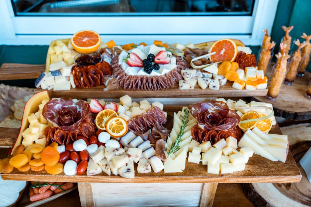 Gourmet charcuterie board with artisan cheese, cured meats, and fresh fruit for weddings & parties.