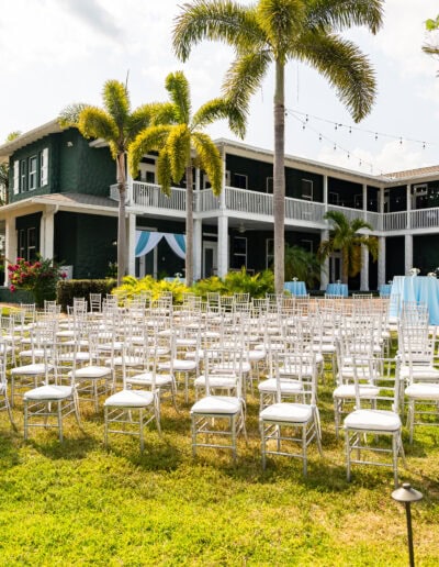 Host your dream wedding at Saint Patrick Palace! This outdoor ceremony setup features elegant white chiavari chairs, lush tropical landscaping, and a romantic aisle leading to the altar. Perfect for couples seeking a beautiful and versatile Florida wedding venue with timeless charm and customizable spaces.
