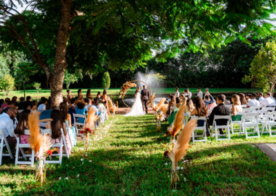 Romantic pampas grass wedding ceremony by the water at Saint Patrick Palace with a round floral arch.