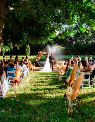 Romantic pampas grass wedding ceremony by the water at Saint Patrick Palace with a round floral arch.
