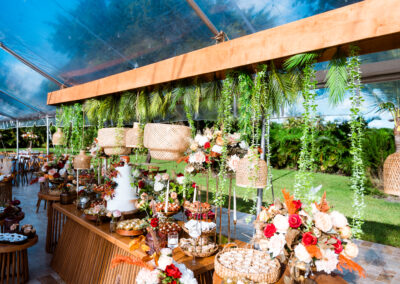 Boho chic wedding dessert table with lush florals, rattan accents & elegant cake styling inspiration.