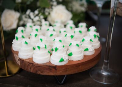 Elegant mini wedding cake favors in white & green – perfect for dessert tables and guest gifts.