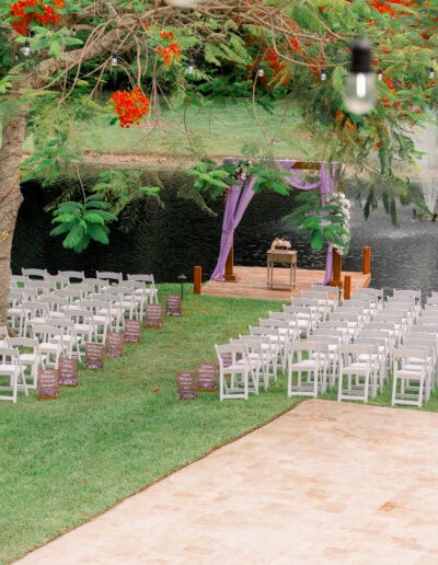 Lakeside wedding with purple draped arbor at a lush outdoor venue in Davie, FL – Saint Patrick Palace.