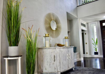 Elegant foyer with gold mirror, console table, and decor at Saint Patrick Palace