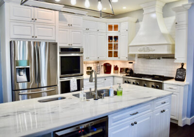 Luxury kitchen at Saint Patrick Palace with marble island, chef’s appliances, and custom white cabinetry in Davie, Florida