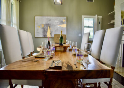 Elegant dining room at Saint Patrick Palace with handcrafted wood table, high-back chairs, and modern décor in Davie, Florida