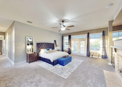 Saint Patrick Palace master bedroom with king bed, fireplace, and private balcony access
