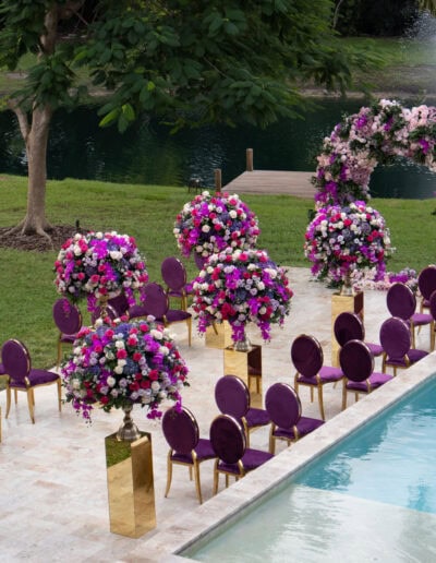 Bold poolside wedding with vibrant florals and luxe seating at Saint Patrick Palace.