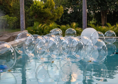 Floating bubble pool décor for an elegant, playful touch to luxury outdoor events and parties.