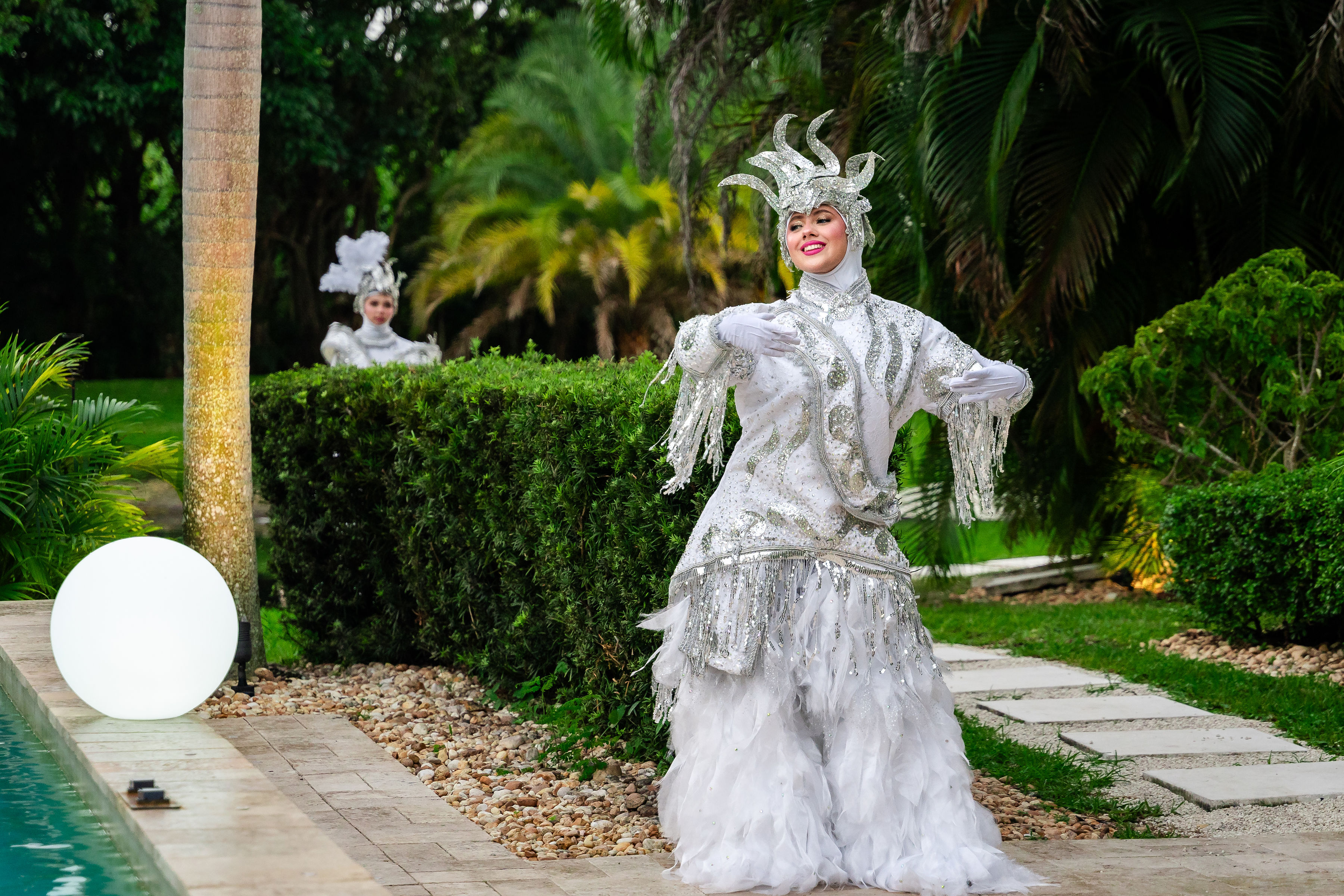 Live performer in shimmering silver costume for a rose gold quinceañera at Saint Patrick Palace.