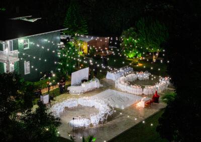 Romantic outdoor night wedding reception with glowing string lights at Saint Patrick Palace, Davie, FL.