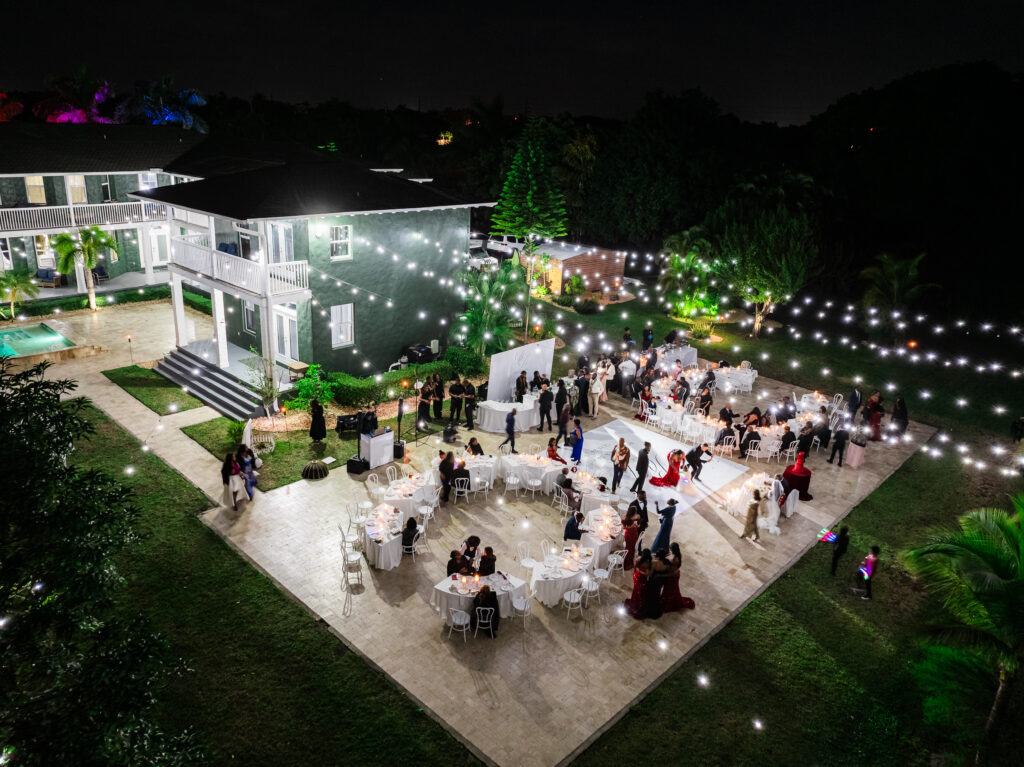 aint Patrick Palace Weekend Wedding Accommodations. Romantic outdoor night wedding reception with glowing string lights at Saint Patrick Palace, Davie, FL.