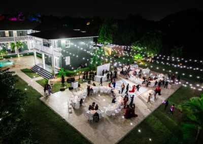 Romantic outdoor night wedding reception with glowing string lights at Saint Patrick Palace, Davie, FL.