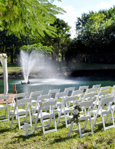 Serene lakefront wedding ceremony setup with draped arbor and fountain at Saint Patrick Palace.