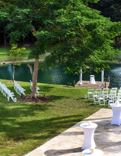 Elegant outdoor waterside wedding with white seating and cocktail tables at Saint Patrick Palace.
