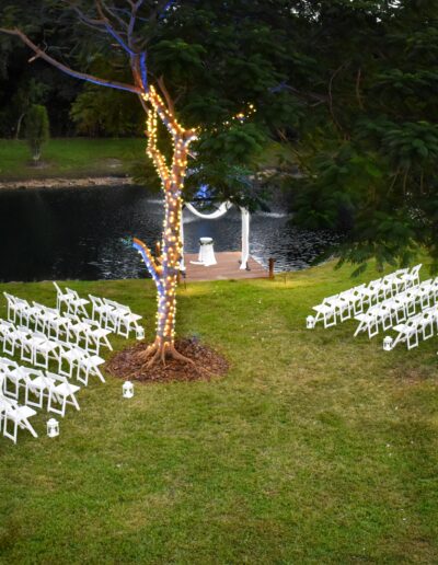 Romantic lakeside wedding setup with glowing tree lights at Saint Patrick Palace.