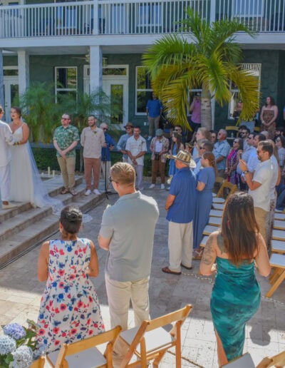 Poolside wedding ceremony with guests at Saint Patrick Palace.