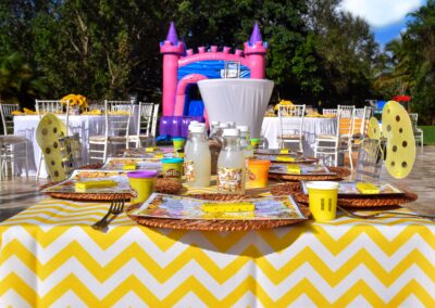 Bright bee-themed kids party table with yellow chevron decor, fun activities, and playful details for birthdays.