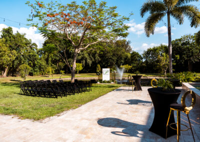 Pondside ceremony setup with black chairs and fountain view at Saint Patrick Palace
