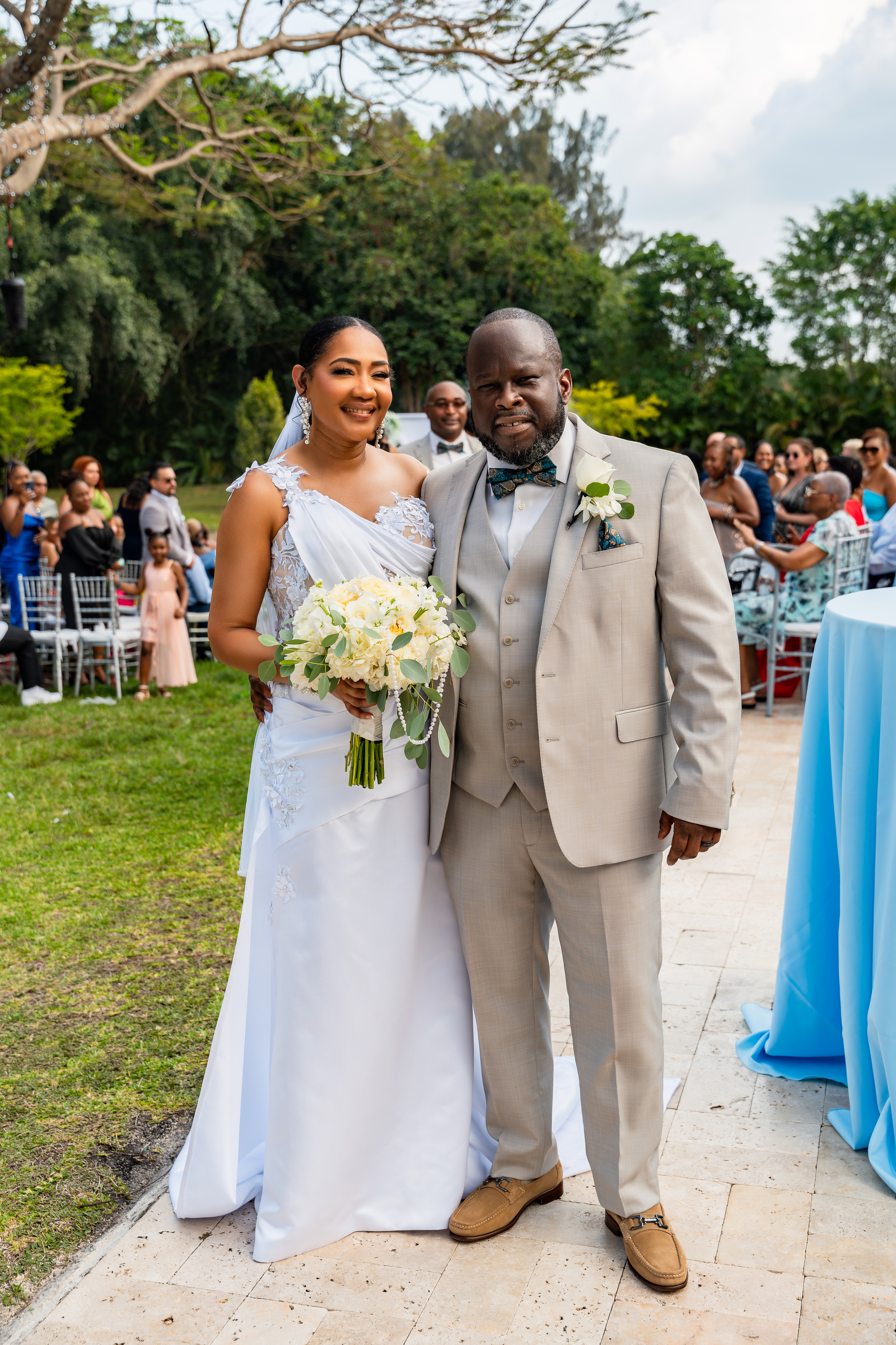 Bride and groom smiling together after their outdoor wedding ceremony at Saint Patrick Palace in South Florida.