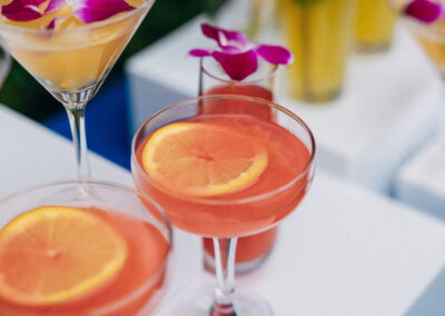 Tropical cocktails with citrus & orchid garnish for weddings, parties & summer celebrations.