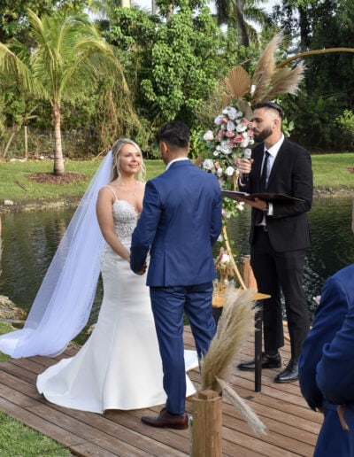 Romantic waterfront wedding ceremony at Saint Patrick Palace with lush florals and serene lake views.