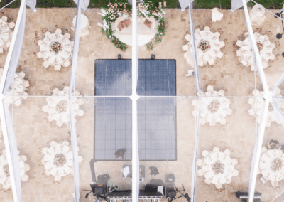 Aerial drone view of a tented wedding reception layout showing table spacing and dance floor placement
