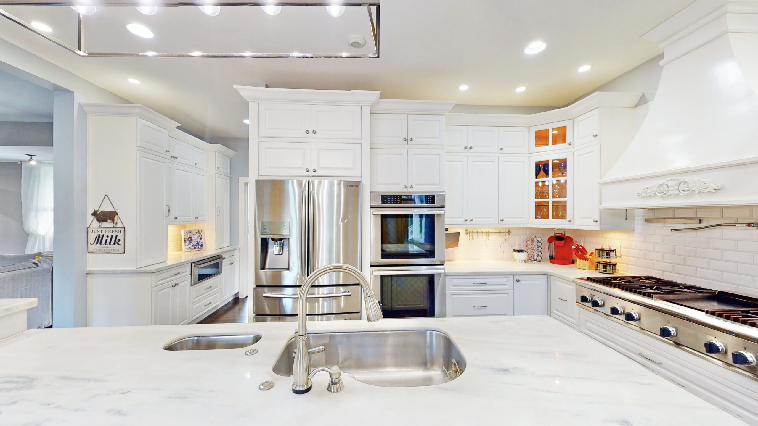 Bright white kitchen for Airbnb backyard graduation parties, perfect for meal prep and hosting guests.