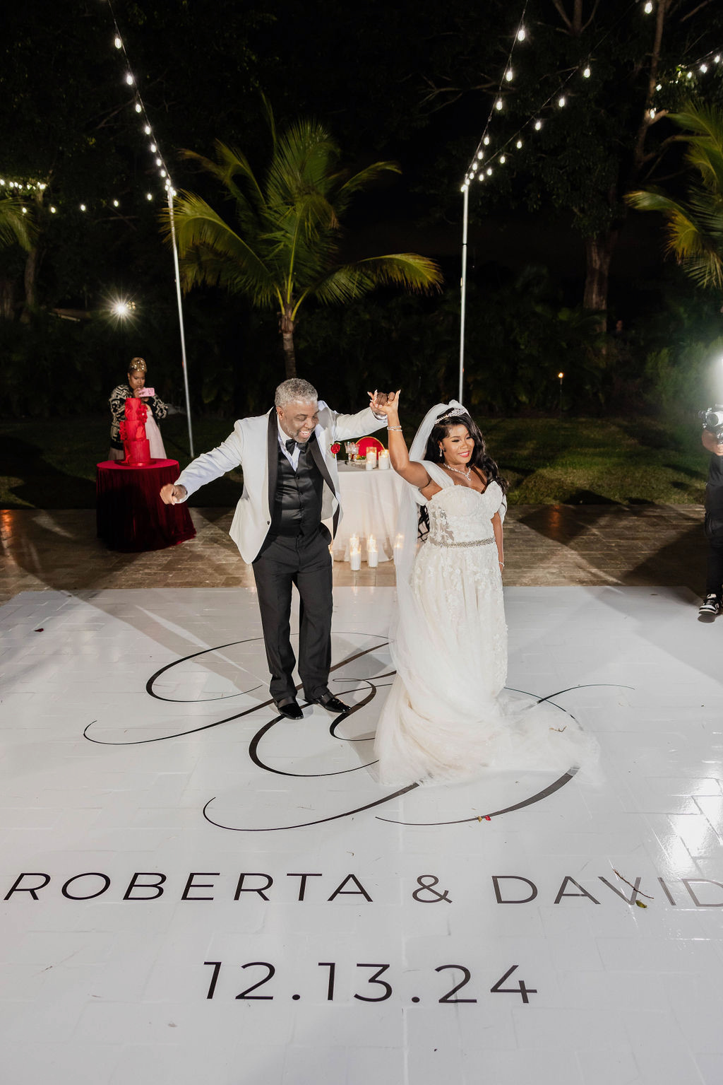 Bride and groom share first dance under bistro lights at Saint Patrick Palace, a luxury Airbnb wedding venue in South Florida.