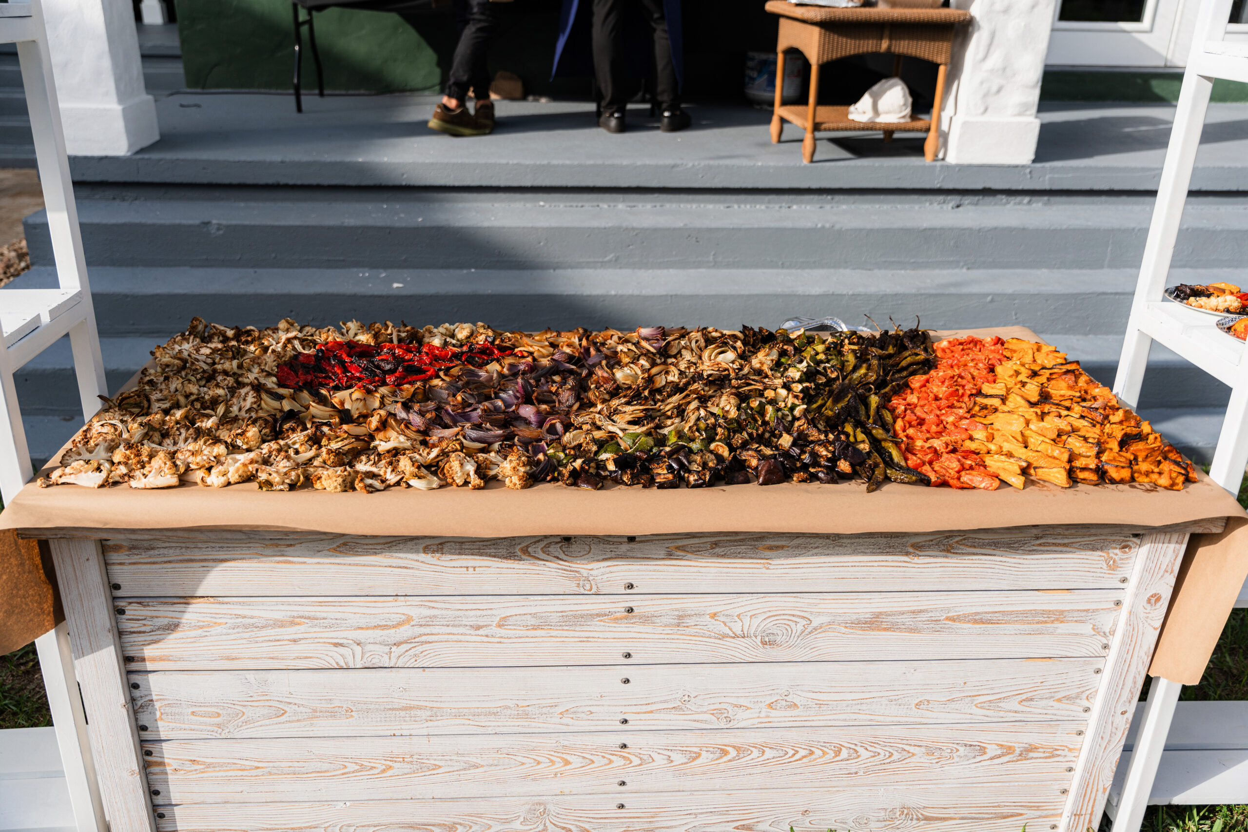 Colorful roasted vegetable grazing table at a South Florida Airbnb wedding reception.