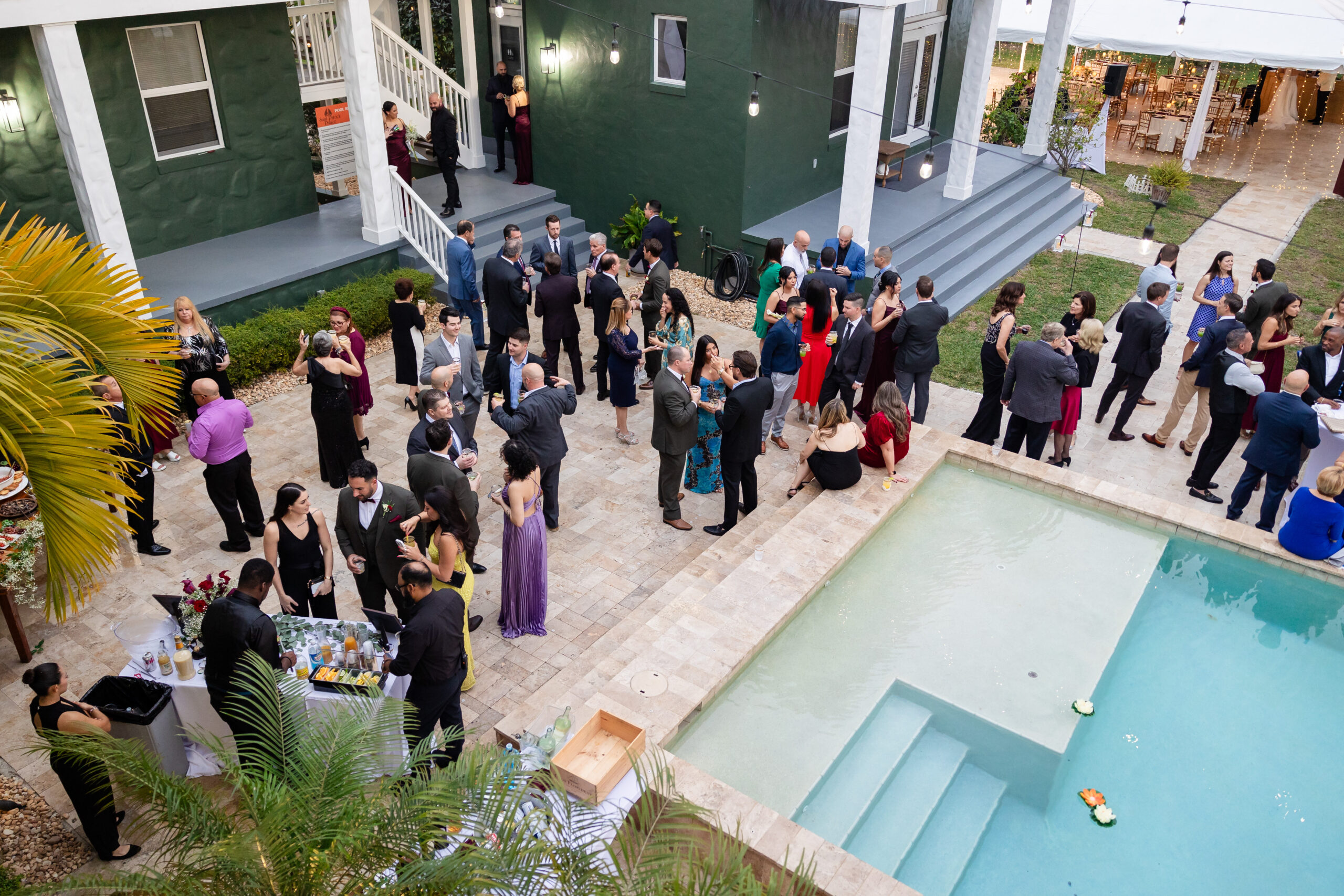 Guests enjoying a poolside welcome party at Saint Patrick Palace, an Airbnb wedding venue near Miami.