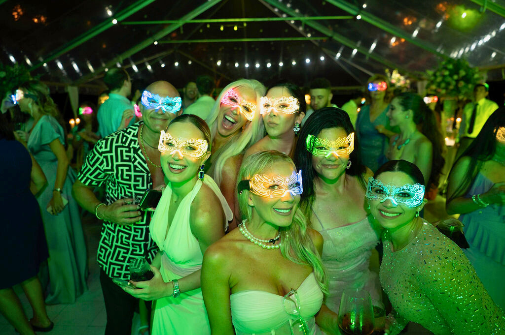 Guests enjoying a masquerade-style bachelor or bachelorette party at Saint Patrick Palace, a luxury Airbnb wedding venue.