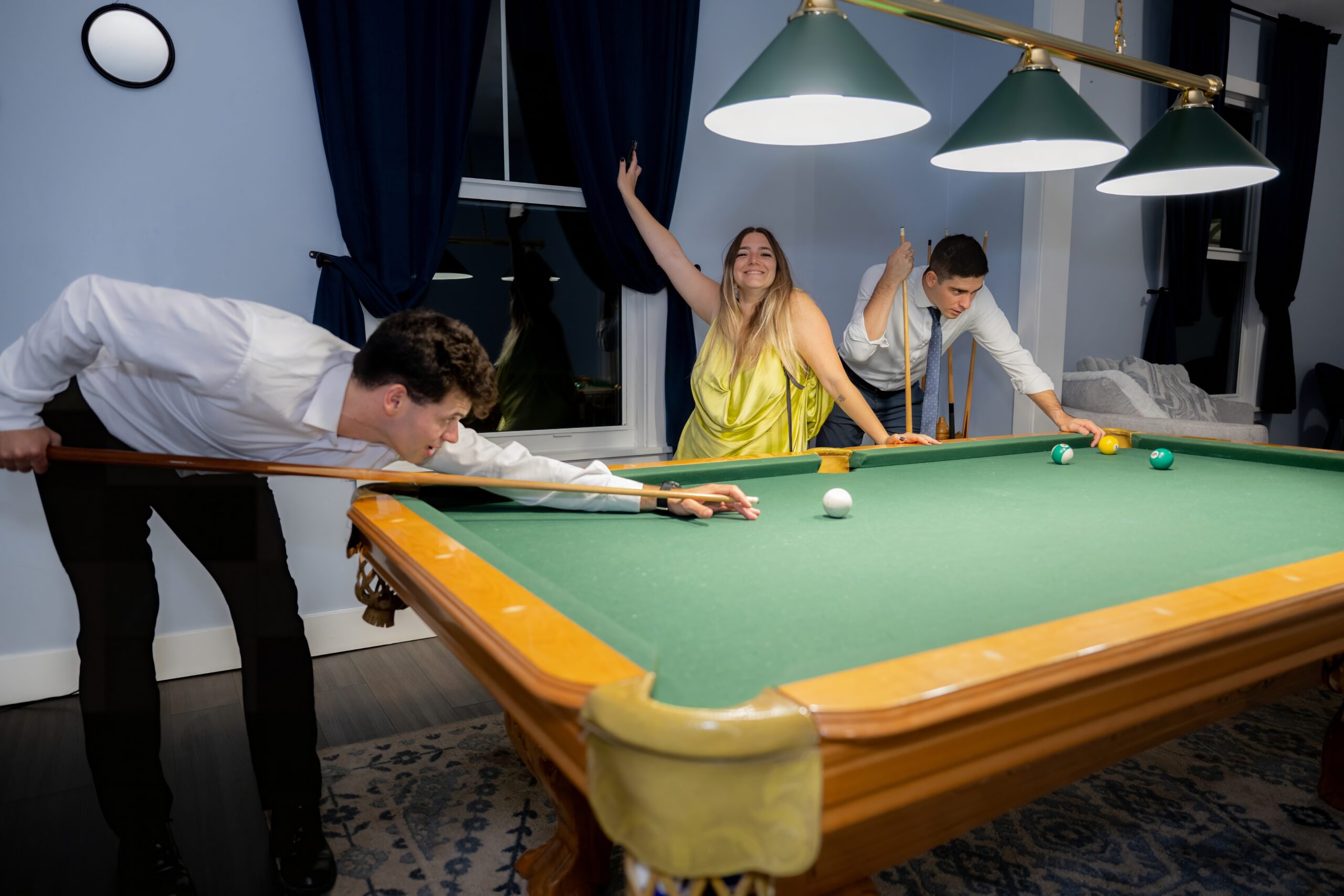 Guests playing billiards inside Saint Patrick Palace during a milestone party celebration.