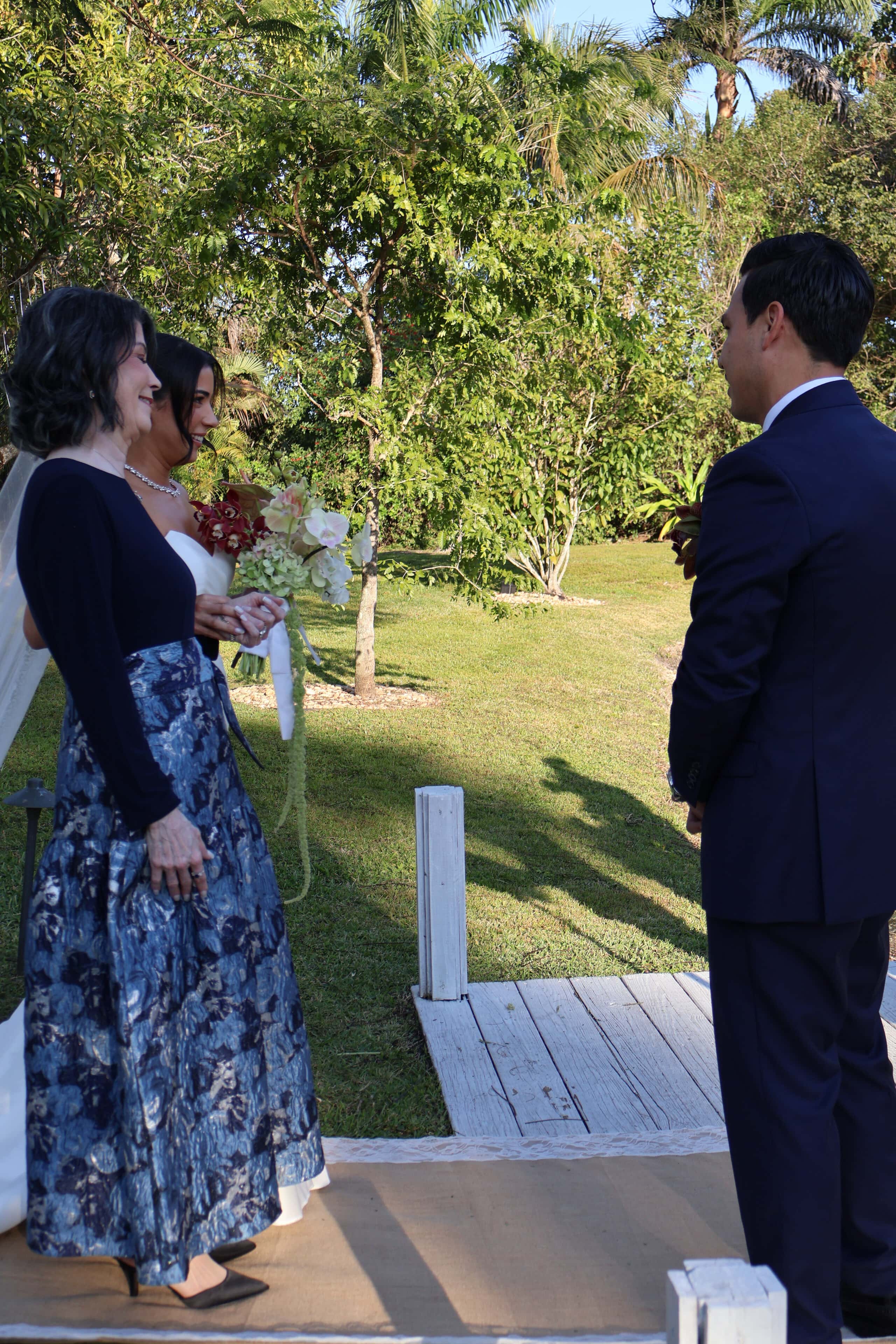 Bride walking to ceremony aisle at Saint Patrick Palace outdoor wedding