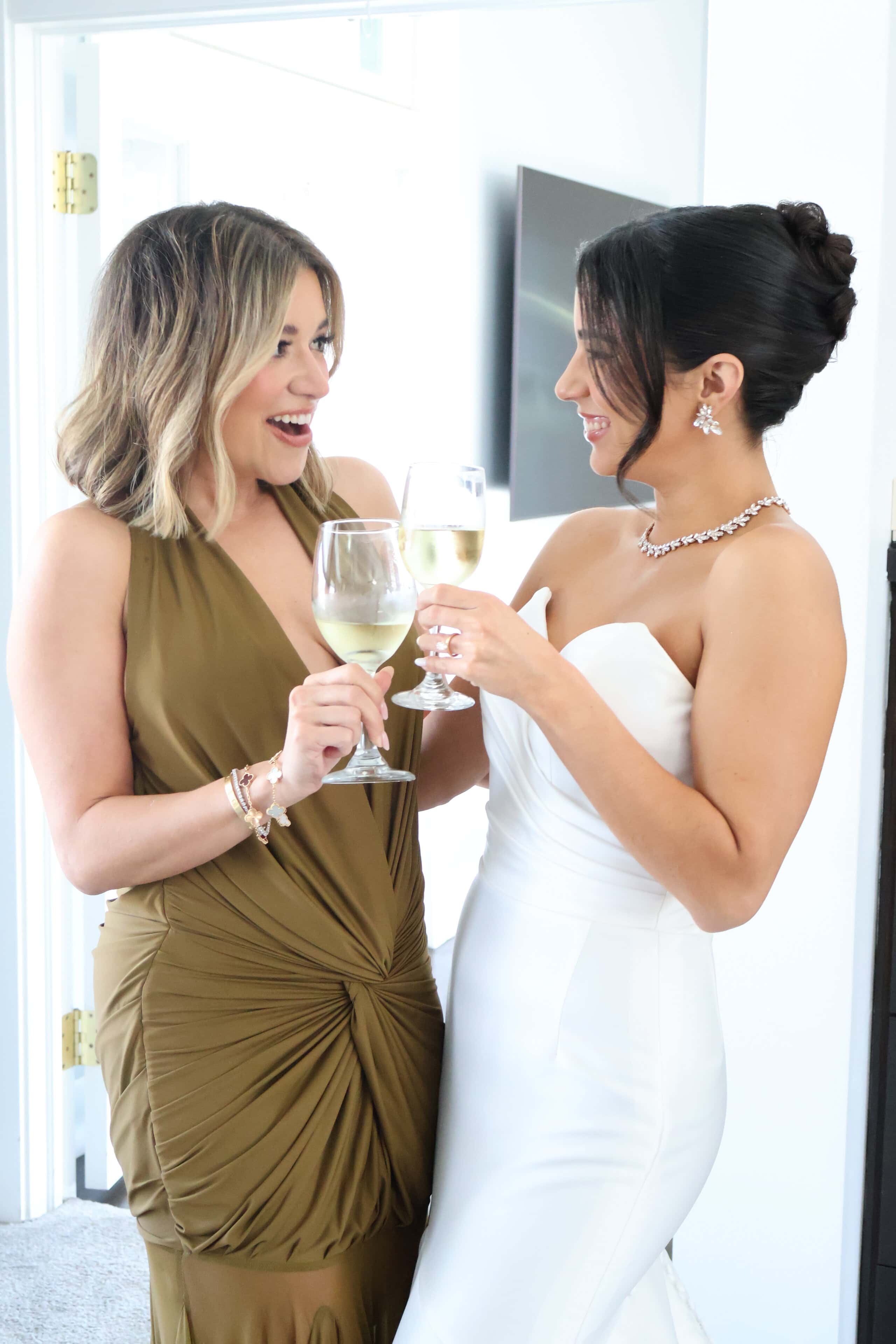 Bride toasting with friend in bridal suite before wedding at Saint Patrick Palace