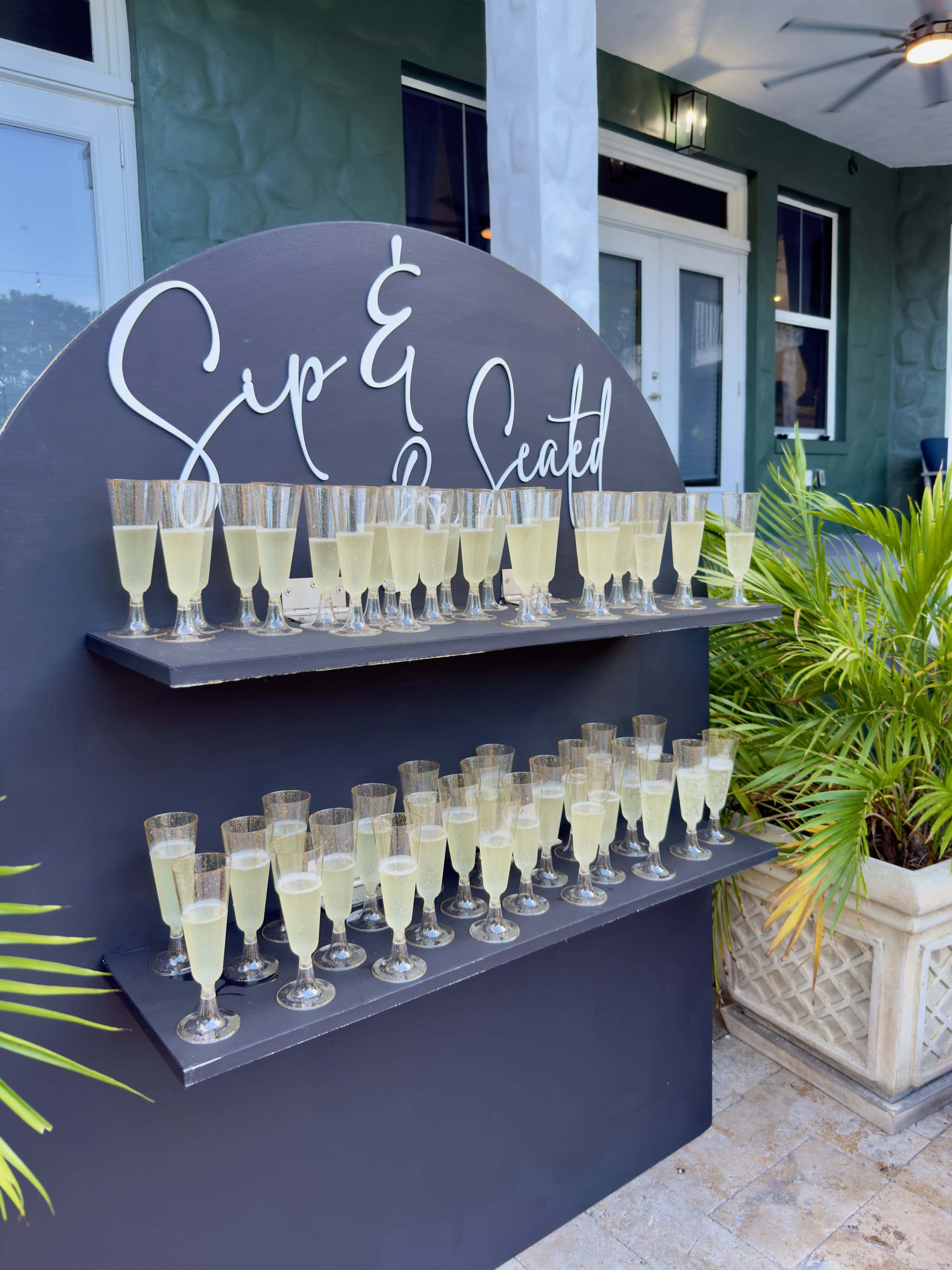 Champagne wall with welcome drinks for wedding guests at Saint Patrick Palace in Davie, Florida