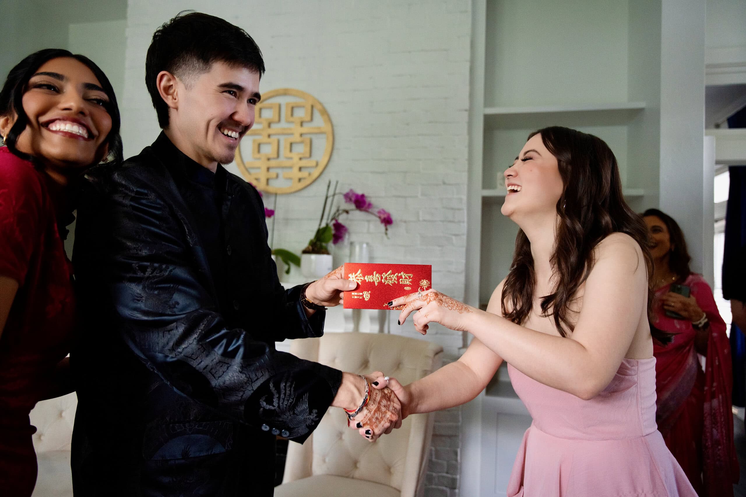 Chinese wedding tea ceremony with couple exchanging red envelope symbolizing prosperity and family blessings