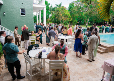 Guests enjoying cocktail hour by the pool at a luxury estate wedding in Davie, Florida.