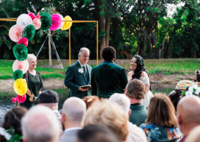 Bride and groom during colorful outdoor ceremony in Davie