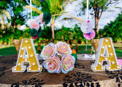 Sweetheart table decorated with floral accents and gold lettering