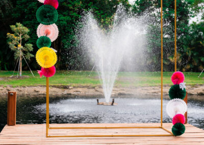 Colorful arch with pond fountain backdrop