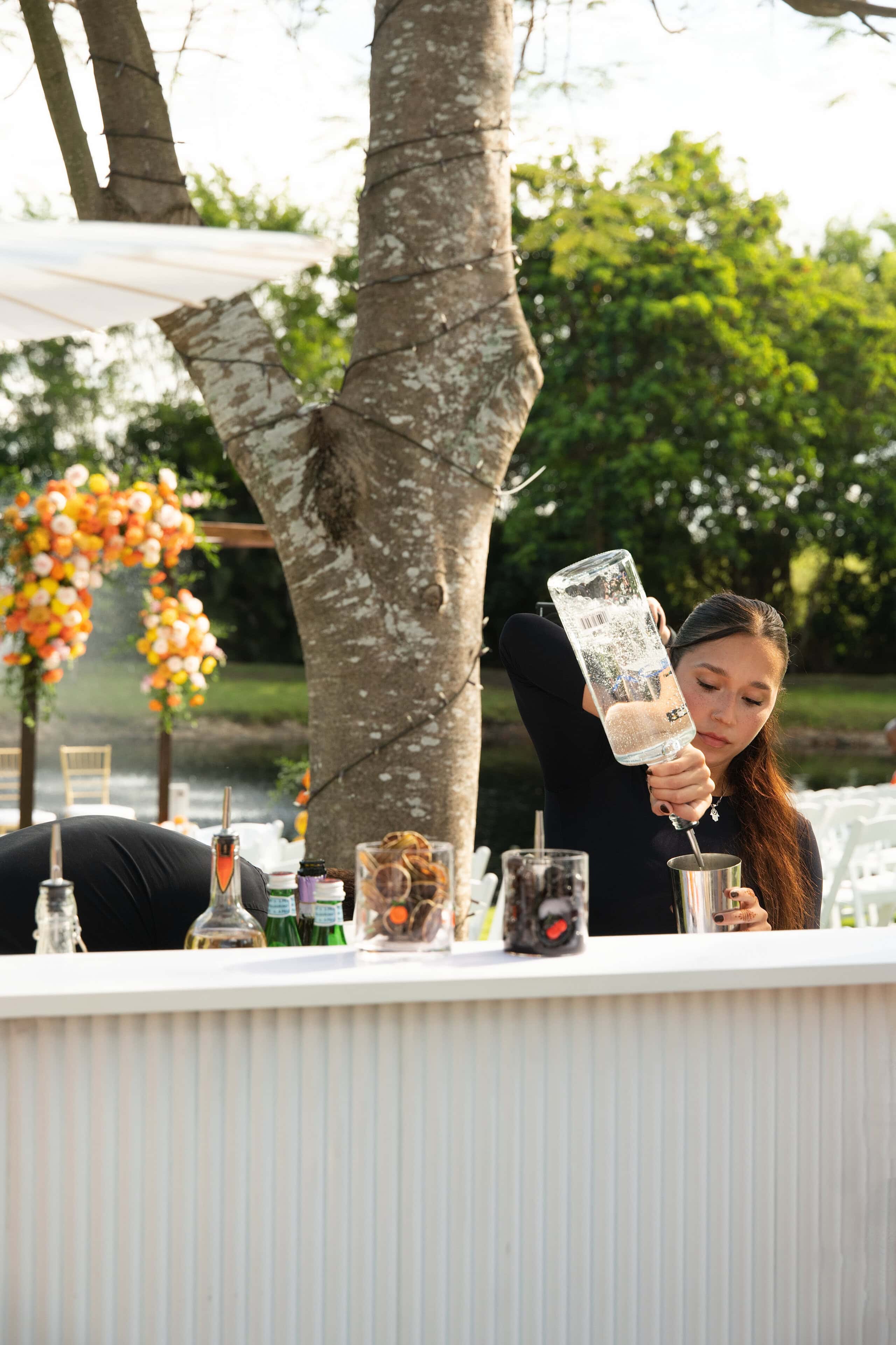 Bartender crafting wedding cocktails at outdoor bar showing open vendor flexibility at Saint Patrick Palace reception