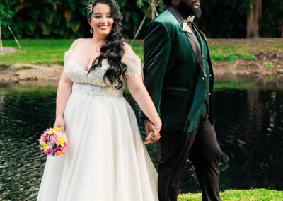 Elegant bride and groom wedding portrait by the lake at a private estate venue.